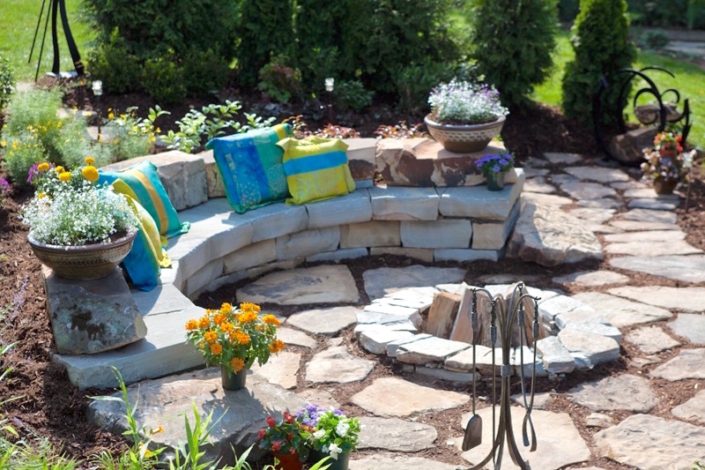 stone sitting wall with stone fire pit