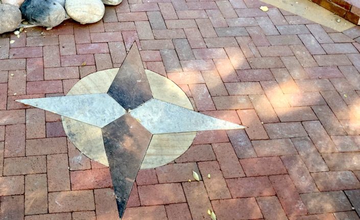 brick patio with stone compass rose