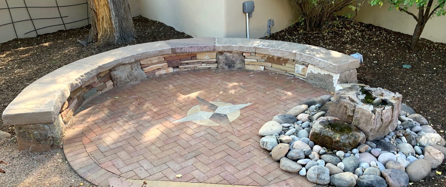 stone sitting wall brick patio compass rose water feature