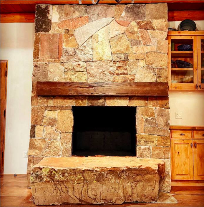 stone fireplace with stone boulder hearth